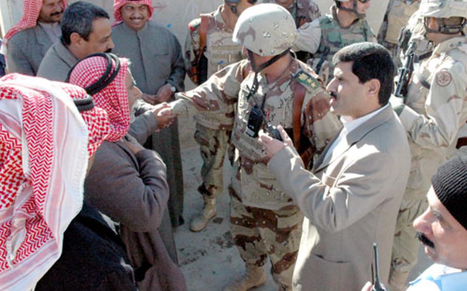 Bi’aj Mayor Abdul Raheem Jasim, accompanied by U.S. and Iraqi army commanders, greets town residents Friday and requests their patience during a daylong cordon and search operation.