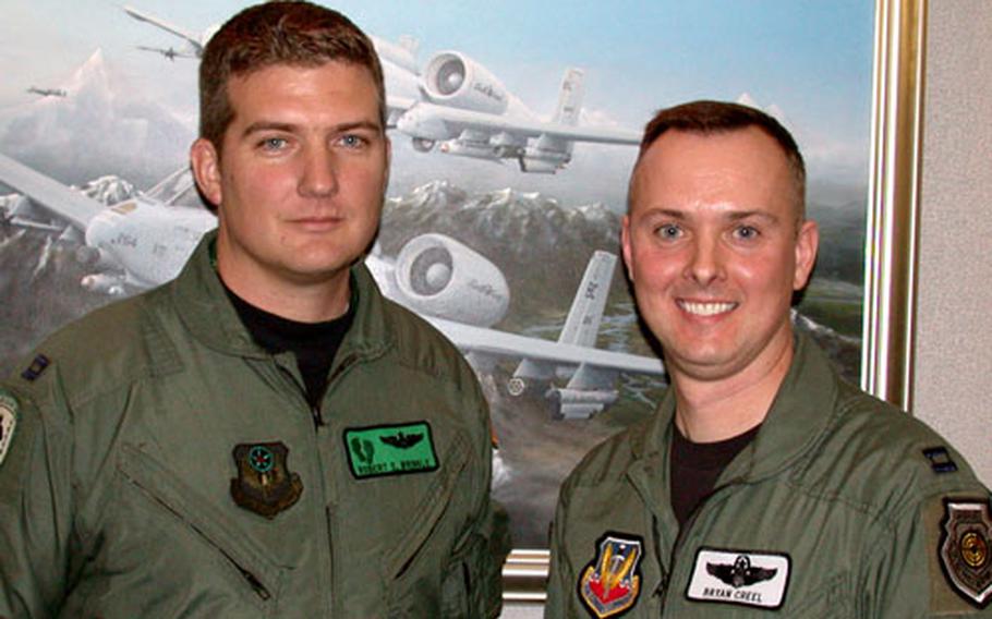Air Force Capts. Rob Wrinkle of the 38th Rescue Squadron, left, and John Bryan Creel of the 41st Rescue Squadron, both at Moody Air Force Base, Ga., led a rescue last year in Iraq that earned the “Jolly 11” and “Jolly 12” crews the prestigious 2004 Air Force Clarence MacKay Trophy.