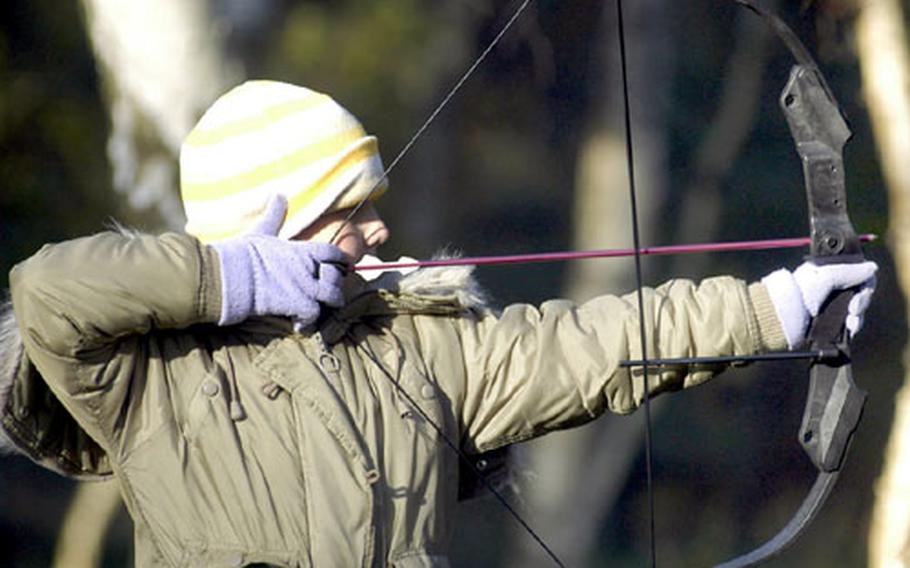 Ten-year-old Amy Hillsden pulls back her compound bowstring as she prepares to fire an arrow at a nearby target. Hillsden, from Dagenham in Essex, was shooting at the RAF Lakenheath Liberty Archers club grounds near the base. About 40 percent of the 50 or so club members are local British citizens.