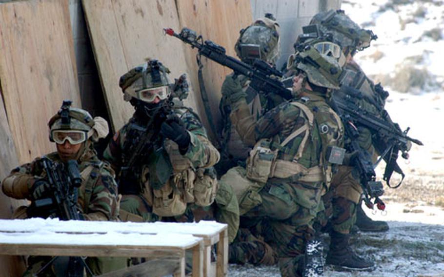 Soldiers take position outside an enemy hideout during an exercise at Rodriguez Range on Tuesday. The two-part exercise also was scheduled to use live anti-tank fire and test decision-making skills for the junior officers of 2nd Battalion, 9th Infantry Regiment, 1st Heavy Brigade Combat Team, 2nd Infantry Division.