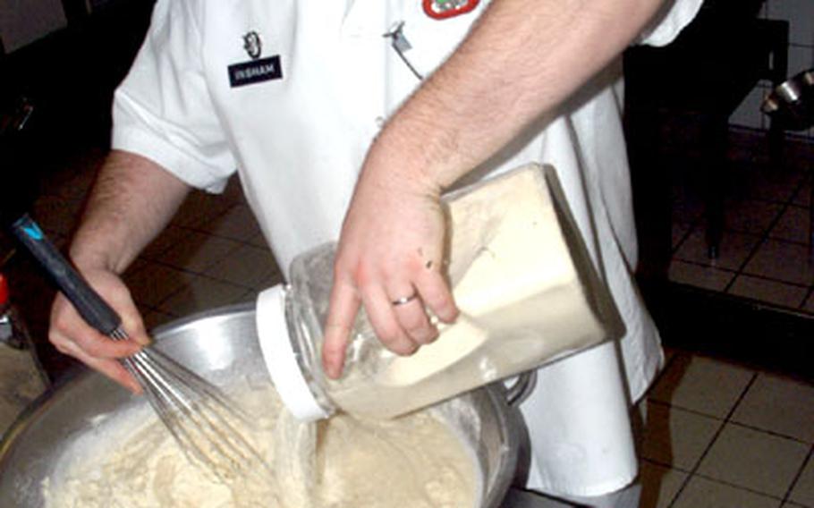 Spc. Kevin Ingham of Headquarters and Headquarters Company, 1st Battalion, 10th Special Forces Group whips up mashed potatoes on Wednesday at the First Choice Dining Facility at Panzer Kaserne.