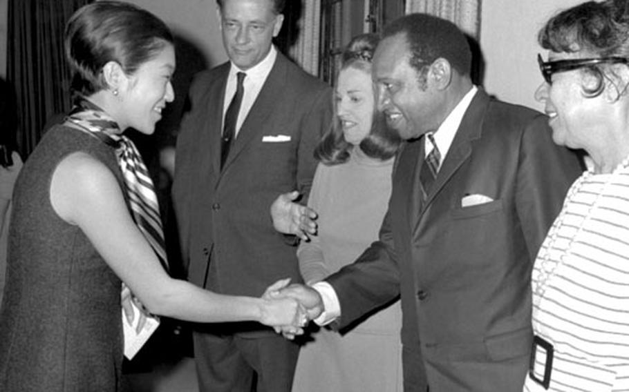Princess Suga of Japan shakes hands with Lionel Hampton at the U.S. Embassy in Tokyo in April, 1969.