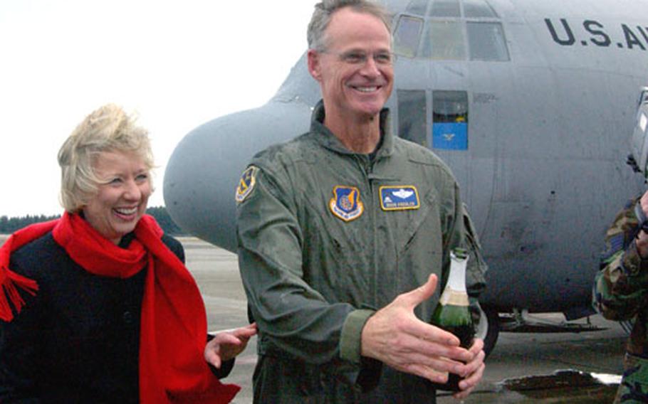 Col. Doug Kreulen, the 374th Airlift Wing vice commander, is joined by wife, Susan, following his ceremonial final flight Tuesday at Yokota Air Base, Japan. Kreulen leaves Yokota next week for the Air Force Academy, where he will become the director of staff.