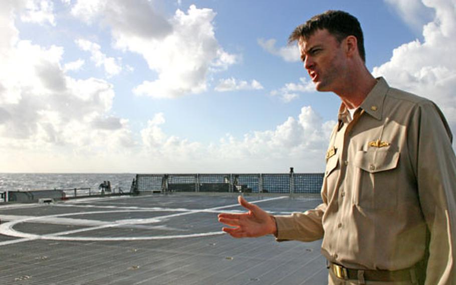 Lt. Cmdr. Phil Pournelle, executive officer of the Swift, stands on the flight deck of the high-speed vessel. One of three leased catamarans in the Navy’s fleet, the ship can carry a maximum of three helicopters.