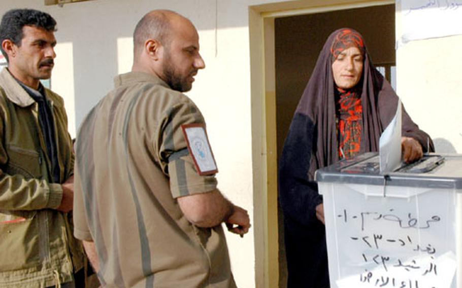 A local resident votes at a polling site in Al Rasheed.