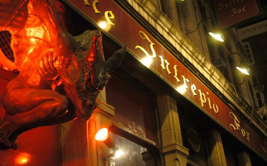 Herald of the goth-rock horrors that await on the inside, the red demon of The Intrepid Fox glowers down over the front door of the London bar.