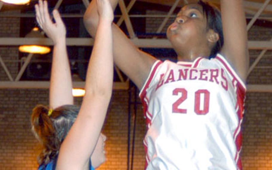 Angelia Gafford shoots over a London Central High School defender in the Lady Lancers' 62-42 victory over the Lady Bobcats.