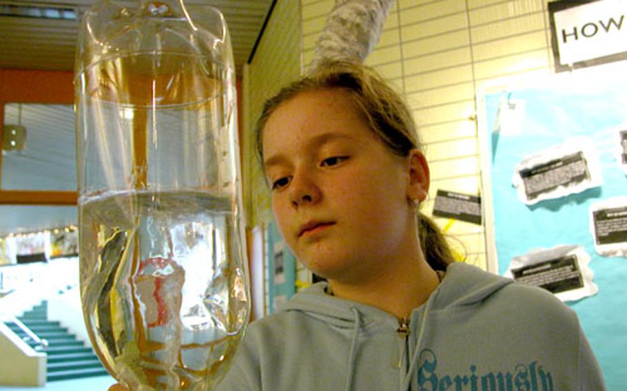 Sophie Gorshenin, 10, concentrates on the cyclone she is ceating using water and a pair of two-liter bottles Thursday at Darmstadt Elementary School, Darmstadt, Germany.