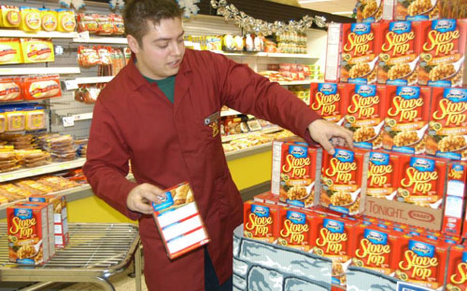 Daniel Paetzold, a worker at the commissary in Hohenfels, Germany, builds a display at the store Friday. Hohenfels won the Director's Annual Golden Performance Award for a large commissary in Europe, and Livorno, Italy, won for small commissary.
