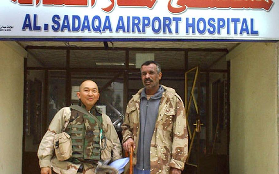 Petty Officer 2nd Class Sid Dacquel, left, stands with Iraqi Sgt. Maj. Kalaf Abalah Nasir in Iraq. Nasir was critically injured in the attack on the dining facility at FOB Marez. Dacquel, a hospital corpsman assigned to the advisory team attached to the Iraqi 11th Army Battalion, helped nurse Nasir to health. However, Nasir was killed several months later.