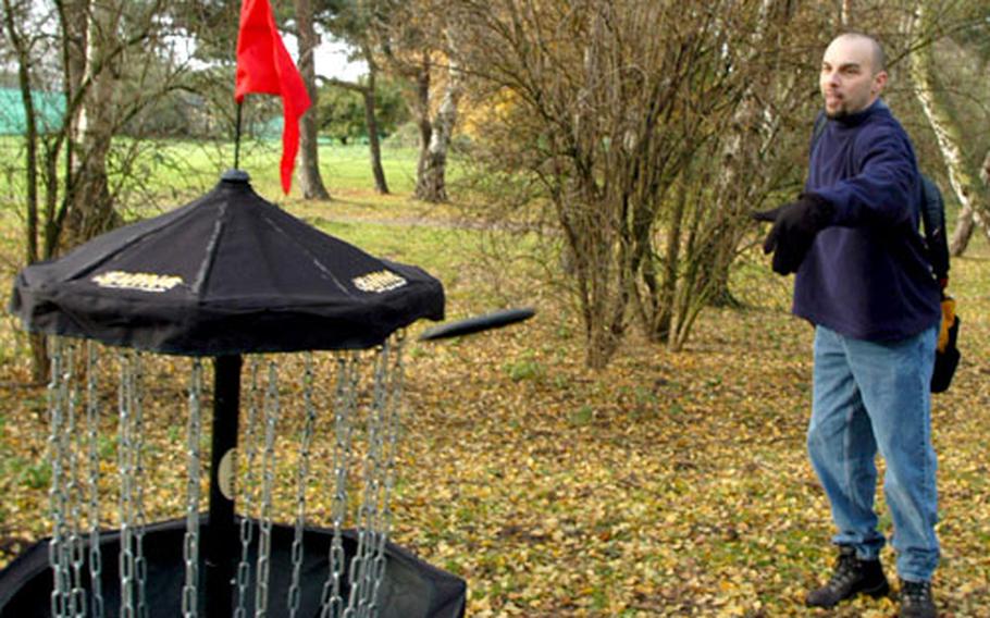Rick Hoffa, a former U.S. Air Force airman turned professional disc golf player, puts on the makeshift course at RAF Lakenheath's Peacekeeper Park.