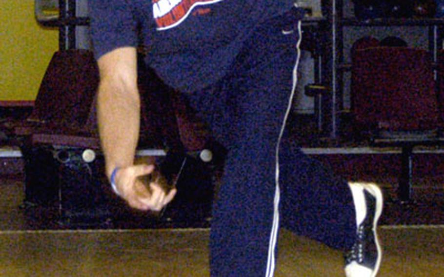 Ed Brandon rolls his ball toward another strike at the RAF Alconbury bowling center. The 24-year-old youth sports director scored a perfect game Nov. 25 during his league play.