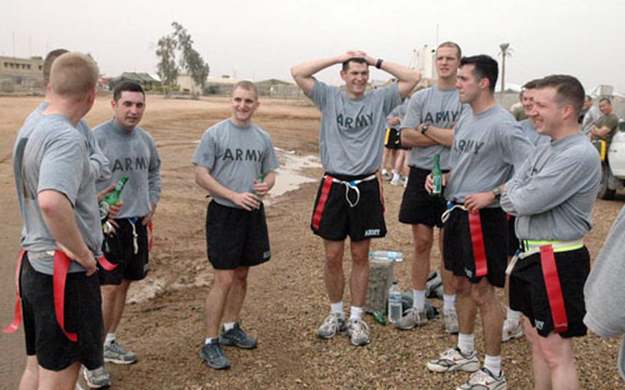 Soldiers of the 54th Engineer Battalion take a break during a Christmas Day flag football game at Camp Ramadi, in Iraq. The unit’s commander said several missions had been planned for the day, but were canceled at the last minute.