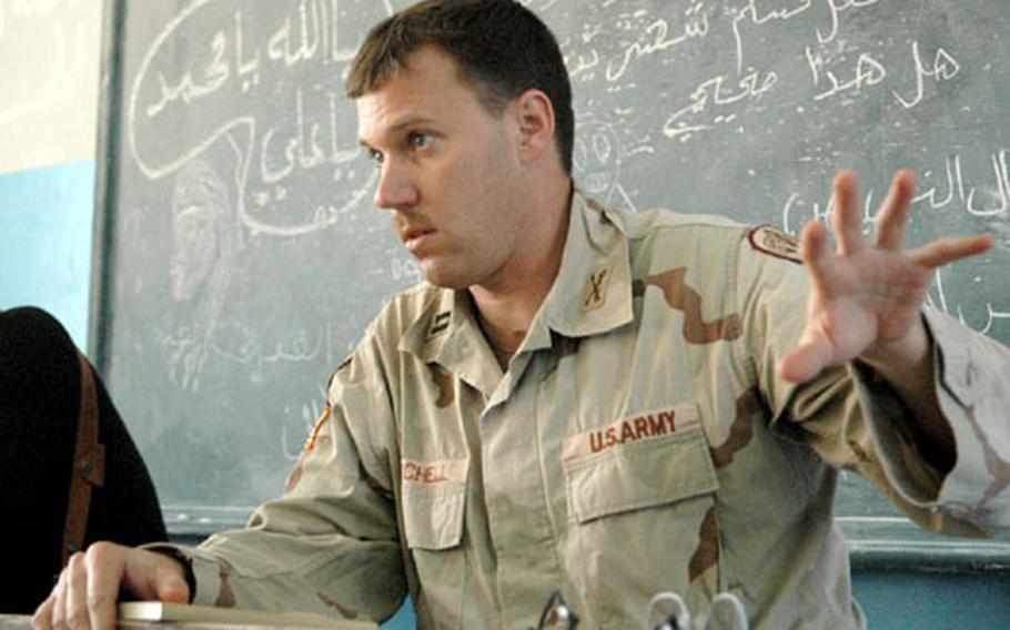 Capt. Gregory Mitchell, commander of Heavy Company, Sabre Squadron, 3rd Armored Cavalry Regiment, speaks in Arabic with a group of local men from the village of Shaykh Ibrahim, Iraq. He’s one of the few to survive an assassination attempt by local officials — in his case, an Iraqi police officer.