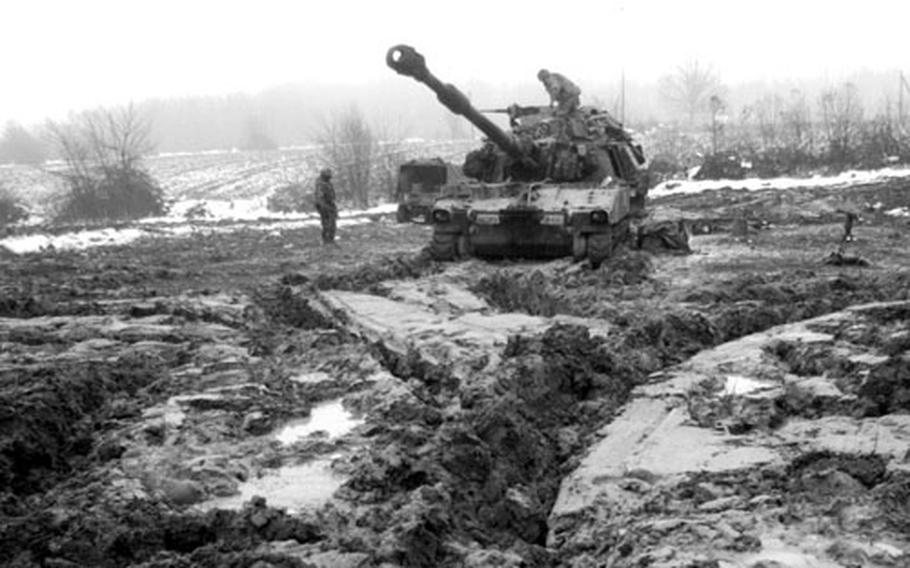 Soldiers from the 1st Brigade attempt to dig their howitzer from the knee-deep mud in January 1996, while setting up camp 45 kilometers north of Tuzla.