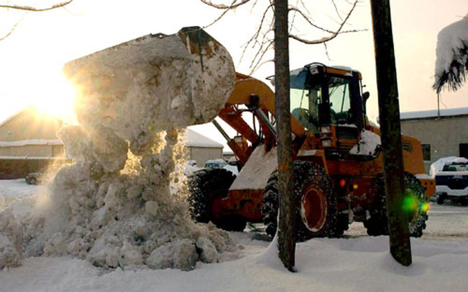 At Kunsan Air Base in South Korea, a worker attacks some of the record snow that battered the base in December. The base has received 73 inches of snow this month, breaking a record set in 1973.