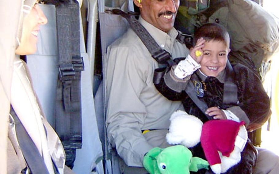 Soldiers of the 236th Medical Company Air Ambulance spent a year evacauting and treating patients in Kuwait, Iraq and Afghanistan. They returned to Germany in late December. In this file photograph, an Iraqi man and son are being taken to get medical treatment.
