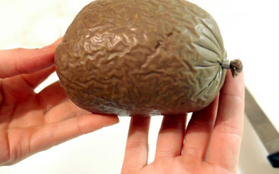 Fresh from the wrapper, an uncooked pork haggis.