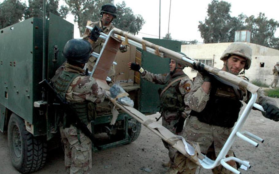 Iraqi army soldiers on Monday unload medical equipment and supplies at the Andalus Medical Clinic in downtown Ramadi. The unloading process was quick because the area remains a dangerous one for troops.