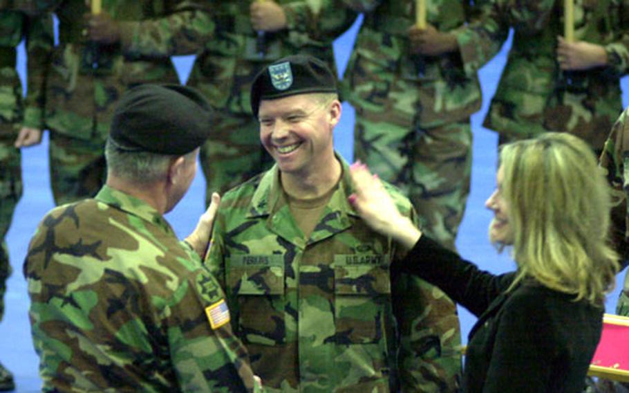 Brig. Gen. David G. Perkins is congratulated by his wife, Ginger, and Gen. David D. McKiernan, commanding general of U.S. Army Europe, shortly after pinning on his first star at Grafenwöhr on Wednesday.