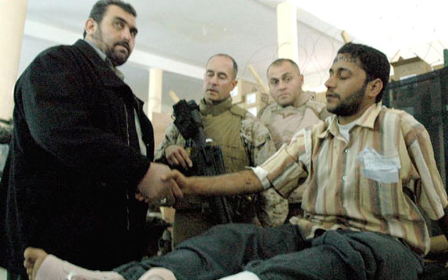 The provincial governor of Anbar visits wounded Iraqi police recruits at a combat hospital on the U.S. base in Ramadi.