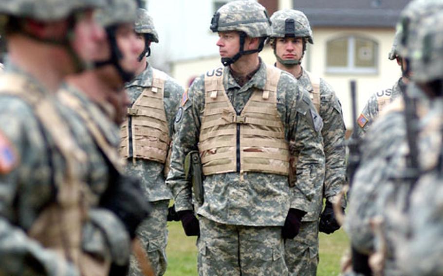 Col. Sean B. MacFarland, commander of the 1st Brigade, 1st Armored Division, watches his troops pass in review at the end of the 1st Brigade Combat Team deployment ceremony at Ray Barracks in Friedberg on Thursday. The 1st BCT is heading to Iraq for its second Operation Iraqi Freedom tour.