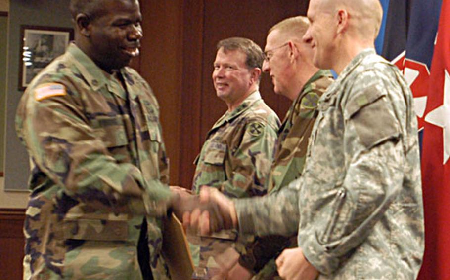 Thirteen 8th U.S. Army units were recognized Friday for their excellence in management and supply by 8th Army leaders. Here, a unit representative shakes hands with Brig. Gen. Steven Anderson, USFK assistant chief of staff for logistics.