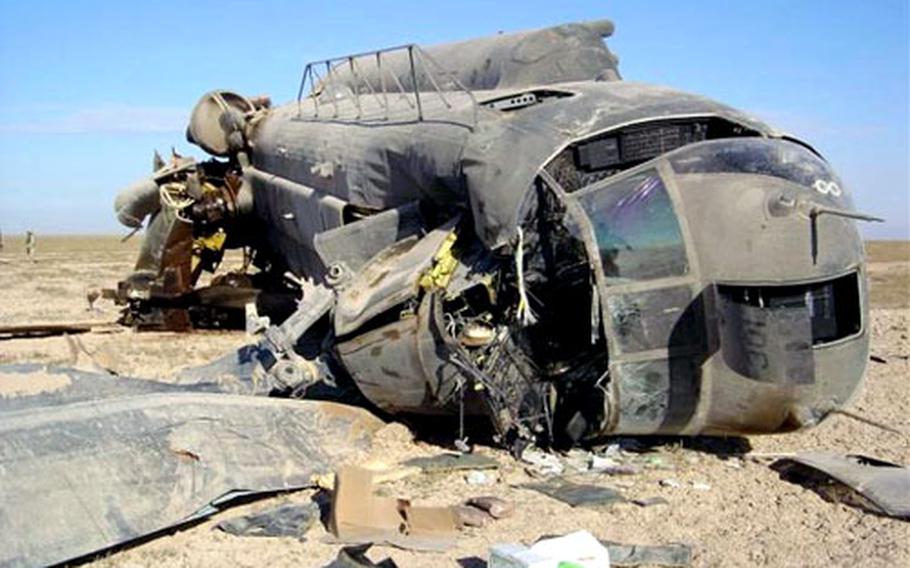 The wreckage of an Army CH-47 Chinook helicopter lies in the Iraqi desert in 2004. Air Force rescue crews, including Kadena pararescuemen Tech Sgt. Michael Rubio and Staff Sgt. John Griffin, rescued its five crewmembers.
