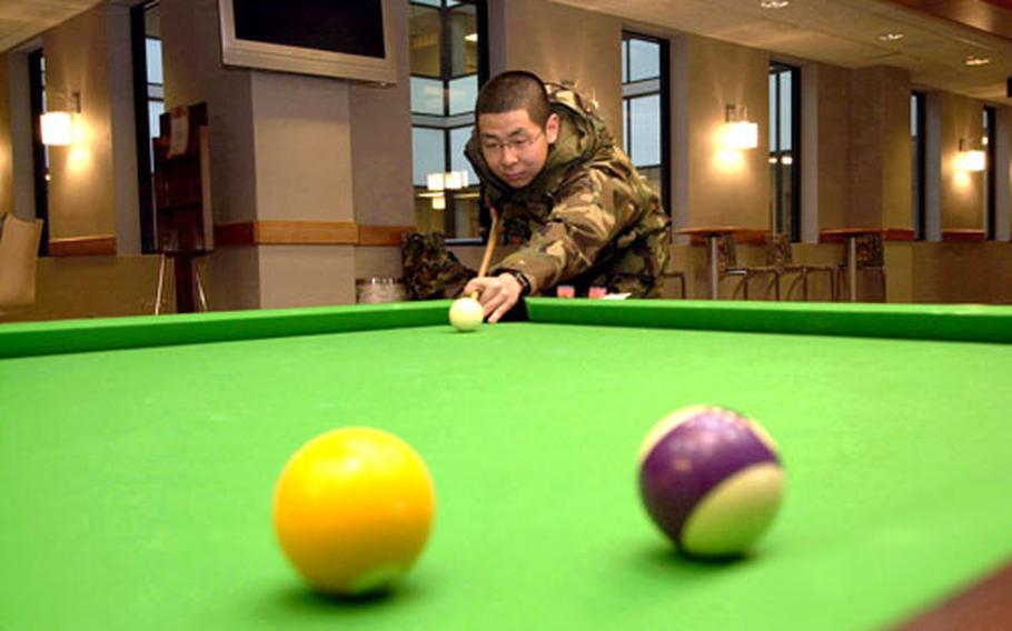 Cpl. Lee Kwan-sung, a Korean Augmentee to the U.S. military, plays pool Friday in the recently opened Community Activity Center on K-16 Air Base, South Korea.