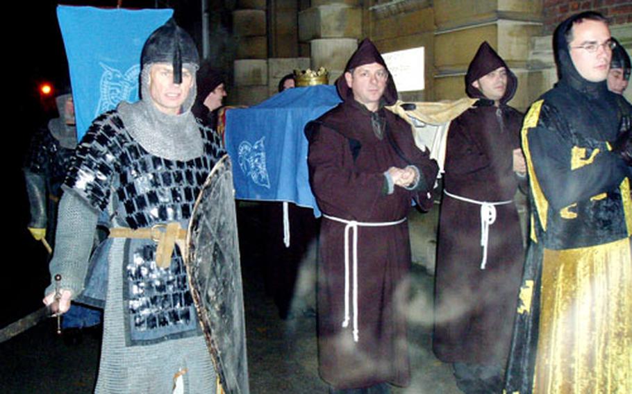 Knights of St. Edmund march through Bury St. Edmunds as part of the ritual to curse a British retail store and developers who plan to build a sprawling Debenhams outlet near the city’s historic downtown area.