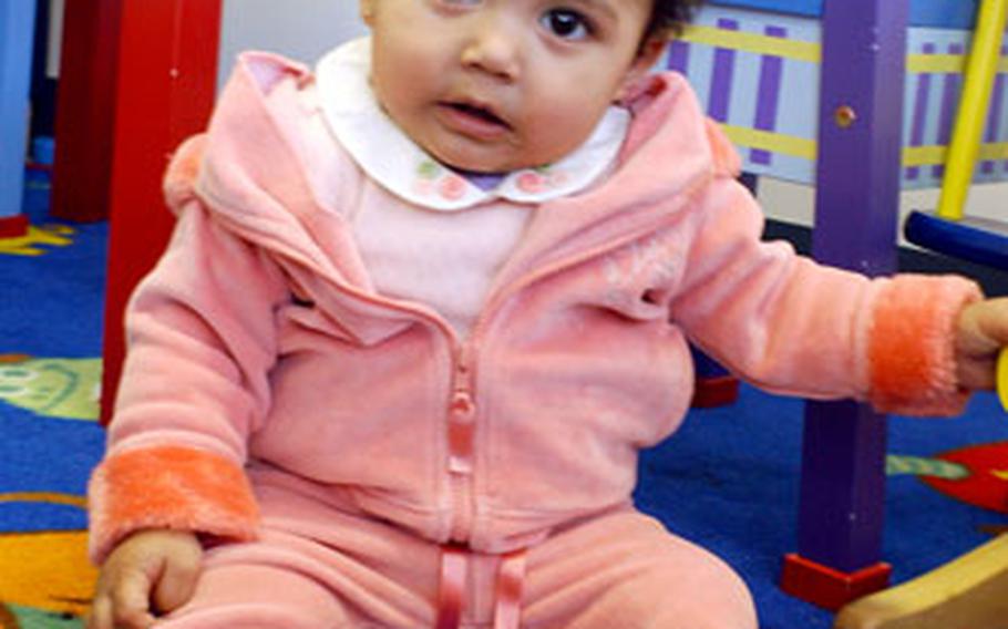 Nine-month-old Mia C. Leyva is entertained in the play area Thursday afternoon at the New Parent Support Office at Marine Corps Air Station Iwakuni. Program nurses Karen Holland and Beth Terrasse are offering a parents’ workshop Friday.