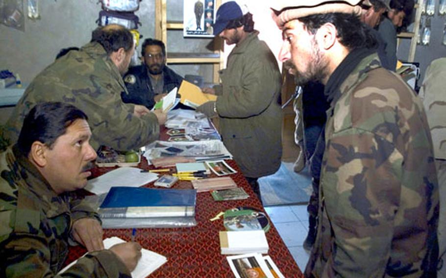 Mujahd Abdoor Rahman, a former Afghan Security Forces member, speaks with a recruiter about his future in the Afghan National Army following an ASF demobilization ceremony Friday in the Paktika province.