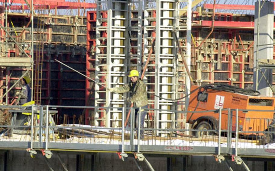 Builders work on the second story of the new elementary school at the Netzaberg housing area under construction in Eschensbach, Germany.