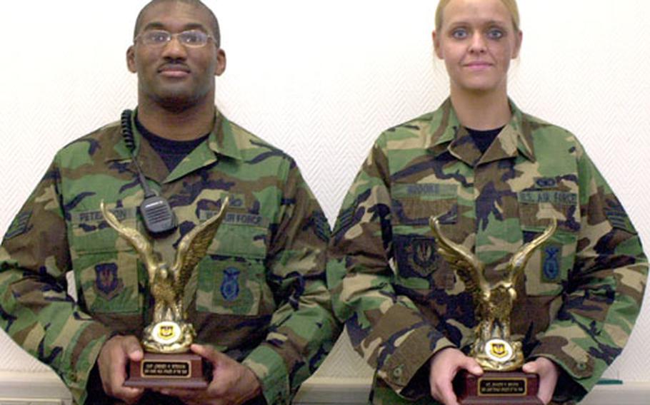 Staff Sgt. Lorenzo Peterson and Airman 1st Class Jennifer Brooks pose with their USAFE athlete of the year trophies Tuesday at Ramstein Air Base, Germany.