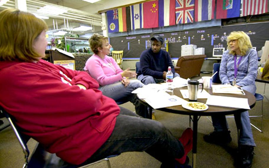 Teachers at Seoul American Elementary School discuss “assessment for learning” during a training session Thursday.