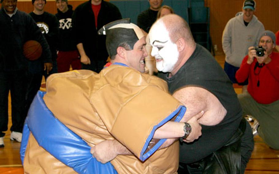 HSL-51 Executive Officer Cmdr. Chris Fletcher, left in sumo suit, and Petty Officer 1st Class John Kirkpatrick go head-to-head on the sumo mat during the Warlords Right Spirit Day.