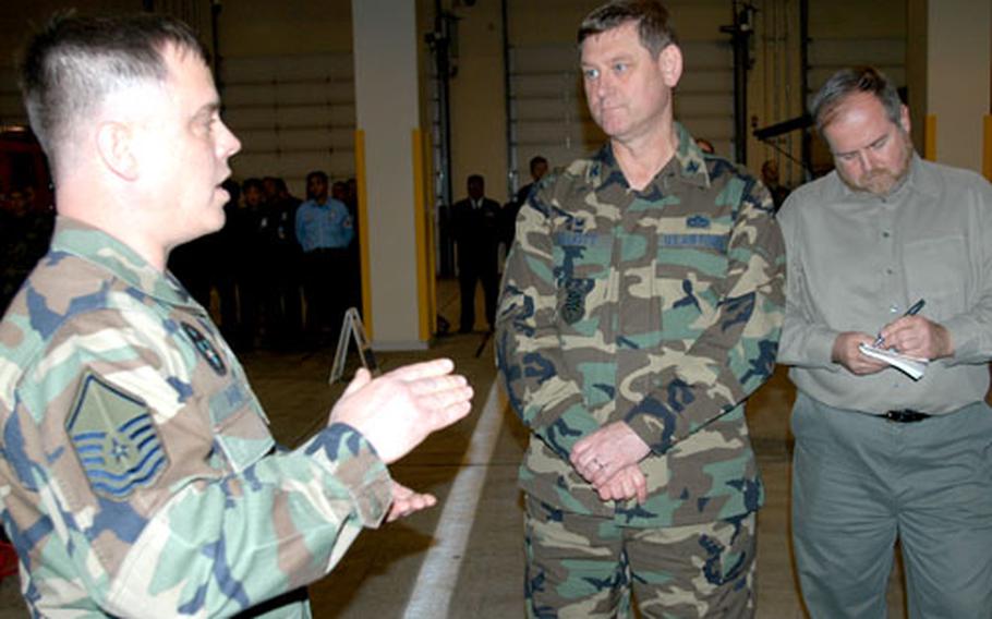 Airman 1st Class Michael Scordato, a 35th Civil Engineer Squadron readiness apprentice, explains the uses for different types of biological- and chemical-detecting equipment to the Curtin evaluation team, including Col. Gus Elliott Jr., center front, and civilian Ian Smith, at Misawa Air Base, Japan, on Thursday.