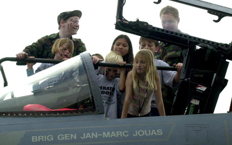 Children examine the cockpit of Brig. Gen Jan-Marc Jouas’ F-15 Saturday at Kadena Air Base on Okinawa.
