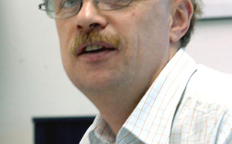 Bradley Flagler, traffic manager for the Defense Commissary Agency, Europe, has excelled at his job despite a degenerative disease that has robbed him of his eyesight.