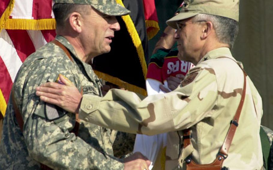 Lt. Gen. Peter W. Chiarelli, left, takes the Multi-National Corps-Iraq flag from Gen. George W. Casey Jr. Chiarelli will command the day-to-day operations of U.S. and coalition forces in Iraq, under the overall command of Casey.
