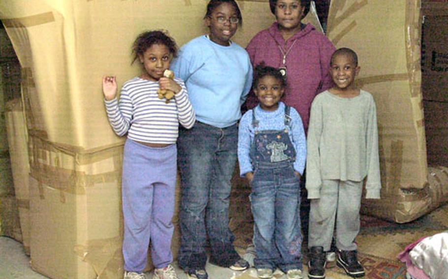 Airman 1st Class Edward Hunter's wife, Dawn, and their four children stand inside their living room at Sembach Annex in Germany on Tuesday before movers took their furniture.