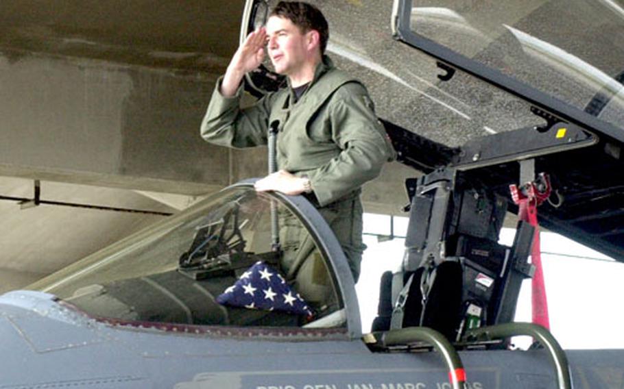 Brig. Gen. Jan-Marc Jouas salutes from an F-15 before his final flight from as commander of the 18th Wing on Thursday at Kadena Air Base, Okinawa.