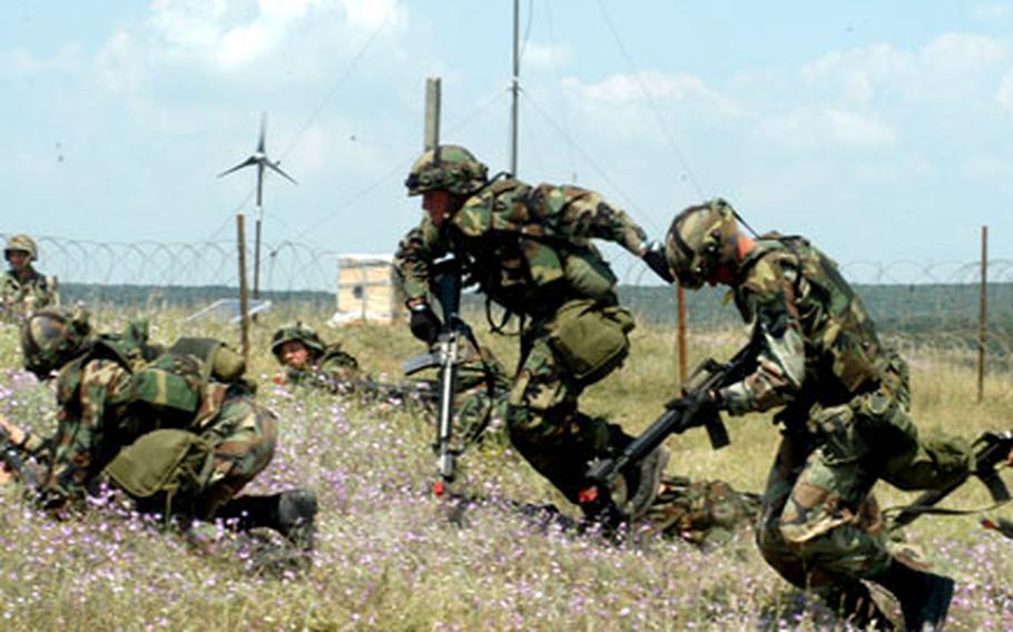 Texas National Guardsmen charge a mock city during urban combat training last summer in Romania. U.S. troops will return to Romania this summer for another round of training.
