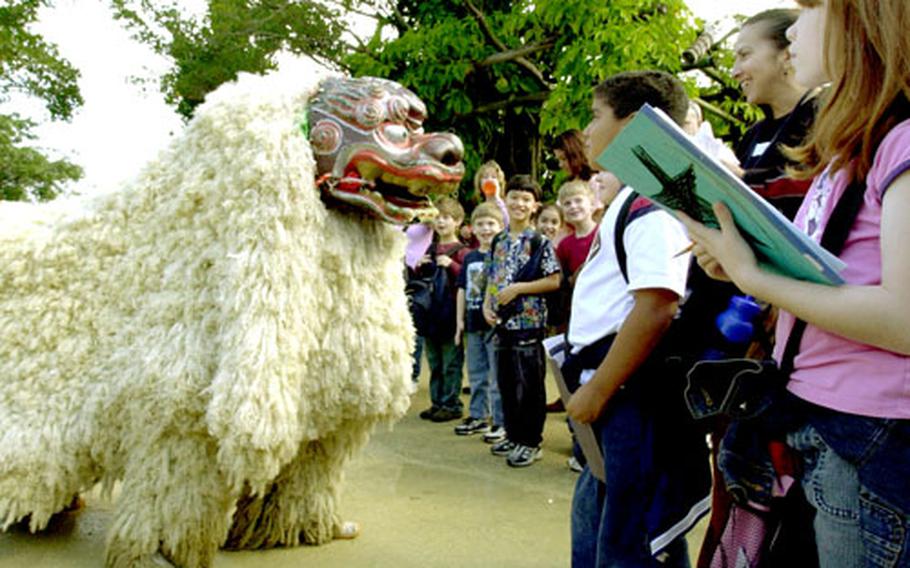 Students from Camp Foster’s E.C. Killin Elementary School are all smiles as performers at Ryukyu Mura demonstrate a shisa dog dance. All multi-age classes from the school went to the reproduction of a traditional Okinawan village on Thursday to learn about the culture of the Okinawan people.
