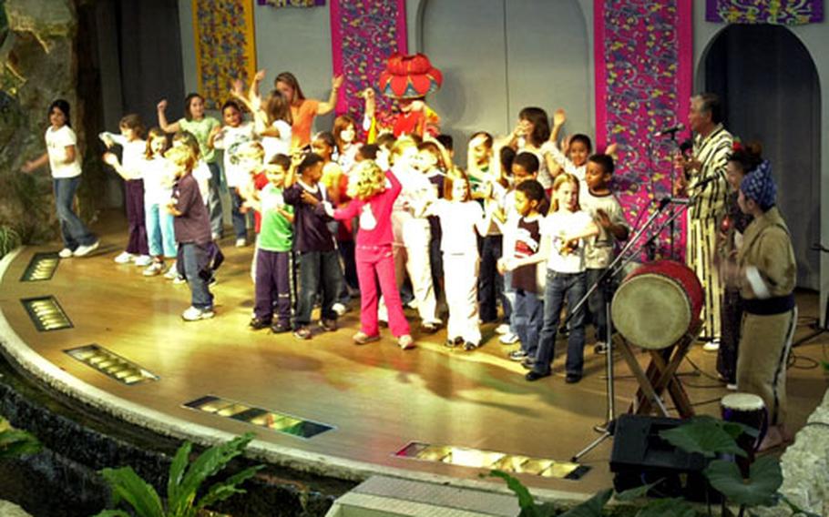 E.C. Killin Elementary School children dance on stage after watching some traditional Okinawan dances at Ryukyu Mura.