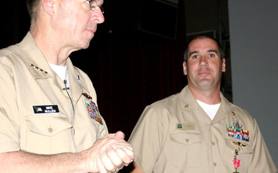 Just prior to his all-hands call at Naval Base Guam on Friday, Chief of Naval Operations Adm. Michael Mullen, left, presented the Bronze Star Medal to Chief Petty Officer Thomas Ligon, of Explosive Ordnance Disposal Mobile Unit 5. Ligon was recognized for heroic achievement while serving in Iraq.