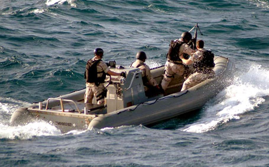A boarding team from the USS Winston S. Churchill approaches a suspected pirate vessel to conduct a boarding and inspection in the Indian Ocean on Saturday.