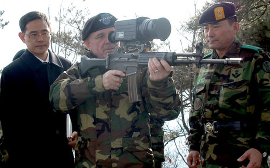 Gen. Leon J. LaPorte, commander of U.S. Forces Korea, inspects a weapon Friday afternoon that South Korean special operations forces use. LaPorte visited the troops on Taehwa Mountain, near Songnam, South Korea.