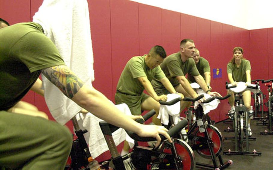 Marines try out the new “spinning” room Friday on the first day of business for the new Gunner’s Gym on Camp Foster, Okinawa.
