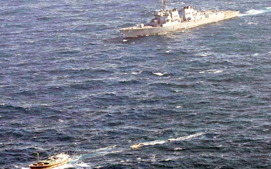 The U.S. Navy’s Arleigh Burke-class guided missile destroyer USS Winston S. Churchill follows a suspected pirate vessel in the Indian Ocean Jan. 21. U.S. sailors later seized the dhow.